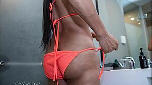 sindy models her orange swimsuit