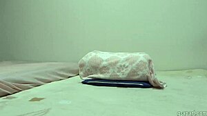 A fair-skinned asian girl in lingerie and stockings feels aroused while masturbating her big tits and boobs