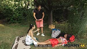 Mature brunette feels huge tits on cock in forest