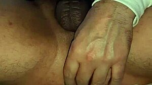 A guy jerks off his big cock until he cums