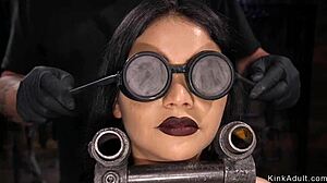 Hey, check out this brunette getting her wet pussy toyed while bound up in bondage