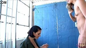 Blonde convict licks brunette guard's ass with strapon.