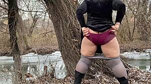 mother-in-law in white pantyhoses and big panties pees outdoors