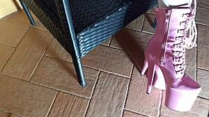 Sitting seductively on chair in tight pantyhose and high heeled boots