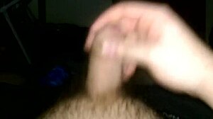 Uncut cock masturbation with cum dripping from the tip.