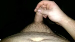 Uncut cock masturbation with cum dripping from the tip.