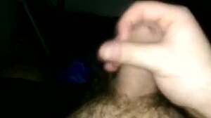 Uncut cock masturbation with cum dripping from the tip.