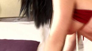 brunette in fishnets relaxing on bed