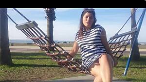 Naked latina girl bent over on public beach