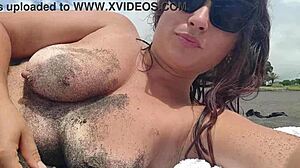 Naked latina girl bent over on public beach