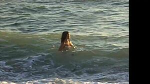 Naked latina girl bent over on public beach