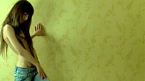 Horny young brunette Sade massages her wet pussy with a dildo in a bent over position