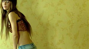 Horny young brunette Sade massages her wet pussy with a dildo in a bent over position