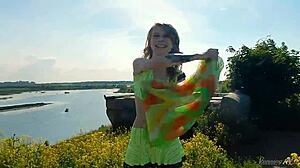 Spunky teen model undresses in miniskirt, exposing tits and pussy during outdoor erotic photoshoot