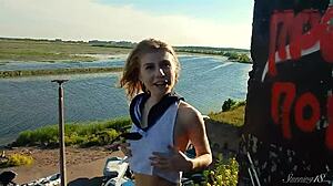 Spunky teen model undresses in miniskirt, exposing tits and pussy during outdoor erotic photoshoot