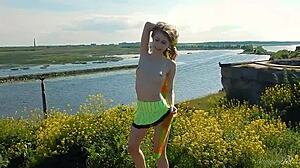 Spunky teen model undresses in miniskirt, exposing tits and pussy during outdoor erotic photoshoot