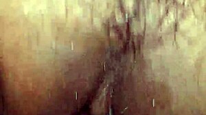 In this intimate moment, a wife watches her husband's hairy cock get hard and wet inside her pussy.