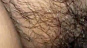 In this intimate moment, a wife watches her husband's hairy cock get hard and wet inside her pussy.