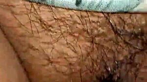 In this intimate moment, a wife watches her husband's hairy cock get hard and wet inside her pussy.