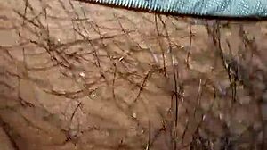 In this intimate moment, a wife watches her husband's hairy cock get hard and wet inside her pussy.