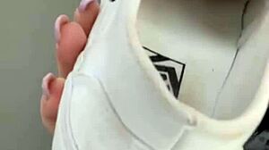 Serbian girl removes her sneakers and shows bare feet.