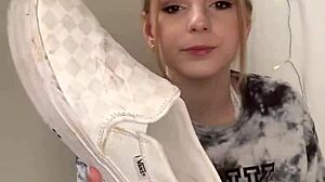 Serbian girl removes her sneakers and shows bare feet.