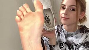 Serbian girl removes her sneakers and shows bare feet.