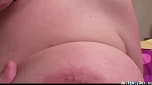 pigtailed brunette teases solo by squeezing and rubbing her big tits in playful amateur display