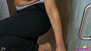 Stunning bronze skin model takes a refreshing shower in the bathroom