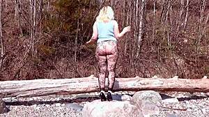 Fishnet pantyhose on big ass blonde babe in forest with natural tits and fetish legs exposed