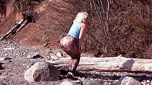 Fishnet pantyhose on big ass blonde babe in forest with natural tits and fetish legs exposed