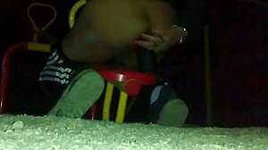 transexual explores outdoor anal masturbation with a dildo in her ass at a public plaza, feeling the thrill.