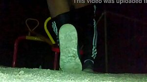 transexual explores outdoor anal masturbation with a dildo in her ass at a public plaza, feeling the thrill.