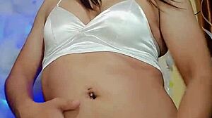 In a cozy setting, the transsexual in pajamas gets ready for some intense masturbation session.