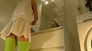 Hot brunette college girl in mini tennis skirt and knee socks shows panties in bathroom