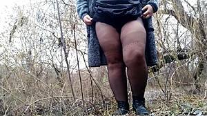 plump mother-in-law's hand rubbing wet pussy through ripped pantyhose outdoors