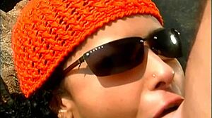 a mature man fucks an exotic babe wearing only a cap and sunglasses on the seaside stones