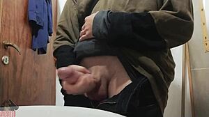 Skinny young guy jerks off his big cock in bathroom