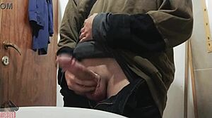 Skinny young guy jerks off his big cock in bathroom