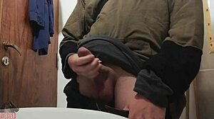 Skinny young guy jerks off his big cock in bathroom