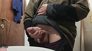 Skinny young guy jerks off his big cock in bathroom