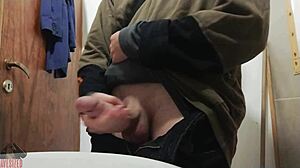 Skinny young guy jerks off his big cock in bathroom