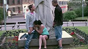 This cute teen 18+ girl gets fucked by 2 guys in public right by the famous statue 😲