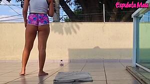 brunette working out outside with shorts wedged in her ass