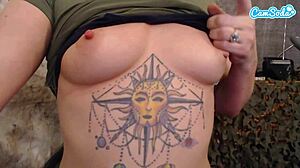 Blonde horny female soldier starts fingering her big tits and pussy on cam