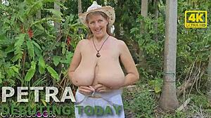 Sexy blonde wife with macromastia contrasts her big saggy tits and hairy pussy on nudist beach