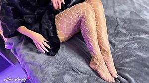 Brunette in fur coat and pantyhose uses vibrator on pussy for squirting close-up