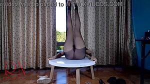 Who knew this seductive lady in pantyhose and heels would striptease so wildly on that round table!