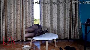 Who knew this seductive lady in pantyhose and heels would striptease so wildly on that round table!