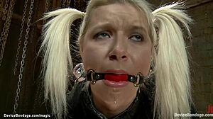 Blonde slave in bondage gets ass shocked with choking and gagging in rough lezdom session.